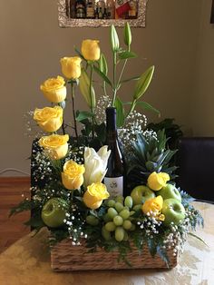 a wine bottle sitting on top of a basket filled with flowers