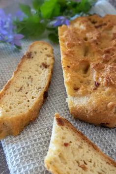 two slices of bread sitting on top of a piece of paper next to some flowers