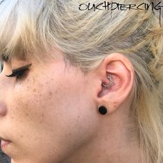 a close up of a person with ear piercings