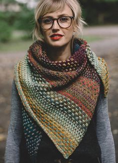 a woman wearing glasses and a multicolored shawl