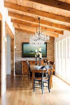 a chandelier hanging from the ceiling in a room with wooden floors and walls