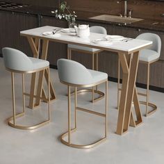 a kitchen table with four chairs and a white marble top, in front of an oven