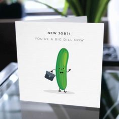 a card with a green pickle holding a cup