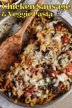 chicken, sausage and veggie pasta in a skillet with a wooden spoon