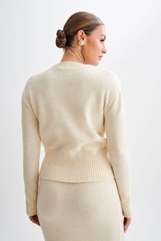 All cozied up.The GENEVIEVE Oversized Knit Cardigan epitomises cozy chic with its luxurious design and effortless style. Featuring a classic round neckline and a functional centre front closure, this cardigan offers both timeless elegance and practicality. The ribbed neckline, hem, and cuffs add texture and detail, while the long sleeves provide warmth and comfort. Crafted from a soft and high-quality knit fabric, it envelops you in comfort while exuding sophistication. Whether matched with the Elegant Cropped Sweater For Winter Workwear, Elegant Winter Cropped Sweater For Work, Classic Cream Cardigan For Layering, Elegant Wool Sweater For Loungewear, Elegant Crew Neck Outerwear With Ribbed Cuffs, Elegant Outerwear With Ribbed Cuffs And Crew Neck, Classic Textured Knit Cardigan For Work, Elegant Crew Neck Cardigan For Layering, Elegant Crew Neck Cardigan For Work