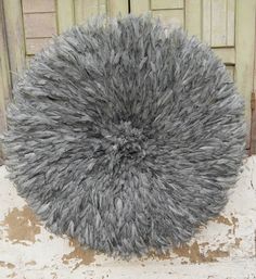 a large gray furry rug sitting on top of a wooden floor next to a door