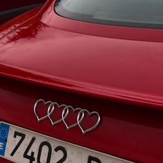 three hearts on the front of a red car