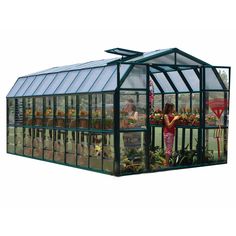 a green house with people inside it