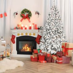 a decorated christmas tree in front of a fireplace with presents around it and candles on the mantle