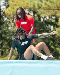 two people are doing tricks on a skateboard