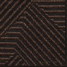 a brown and black area rug with an abstract design