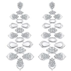 two pairs of earrings with diamonds on the bottom and one is white gold, while the other