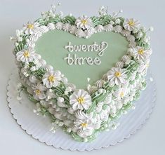 there is a heart shaped cake with flowers on it