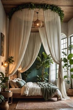 a canopy bed with drapes over it in a room filled with potted plants