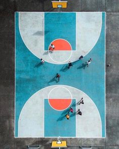 an overhead view of a basketball court with people playing on it and one person standing in the middle