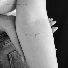 a woman's arm with a small tattoo on the left side of her arm