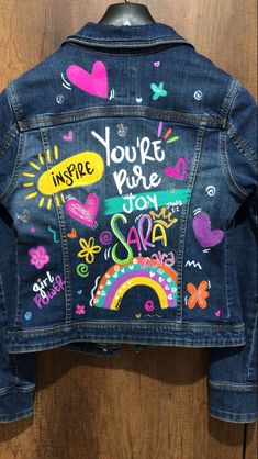 a denim jacket with colorful writing on it