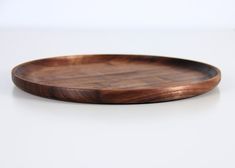 a wooden plate sitting on top of a white table