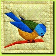 a colorful bird sitting on top of a piece of fabric