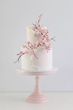 there is a white cake with pink flowers on it