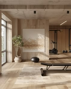 an empty gym with benches and exercise equipment in the background, there is a large painting on the wall