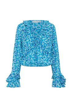 In lightweight cotton voile, the Lombardi Top is a sunshine staple featuring a deep v-neckline, frilled accents, front ties and full length sleeves with exaggerated frilled cuffs. Lovingly hand-printed with vintage-inspired blue florals, style it with linen pants or over swim as a cover up. Long Sleeve Ruffled Blouse For Vacation, V-neck Ruffle Hem Blouse For The Beach, V-neck Blouse With Ruffle Hem For Beach, V-neck Beach Blouse With Ruffle Hem, Beach V-neck Blouse With Ruffle Hem, Vacation V-neck Blouse With Ruffle Hem, V-neck Ruffle Blouse For Daywear, Blue Florals, Long Sleeve Floral Top