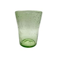 a green glass with water drops on it