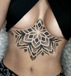 a woman's stomach with a tattoo design on the top and bottom part of her body