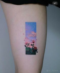 a woman's thigh with a painting on it that has roses growing out of the ground