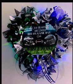 a football themed wreath is shown with the words, our hearts are united but on game day or house divided