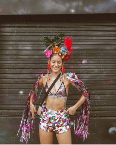 a woman in colorful clothing standing next to a garage door with her hands on her hips