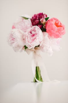 a bouquet of pink and white flowers on a table