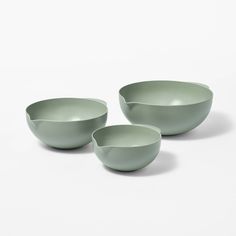 three green bowls sitting next to each other