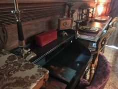 an old fashioned dining room table and chairs with candles on top of the tables in front of them