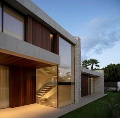 an exterior view of a modern home with stairs leading to the upper floor and second story