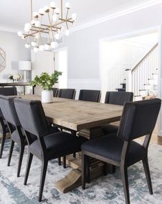 a dining room table surrounded by black chairs