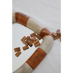 a white and brown object with wooden blocks on it