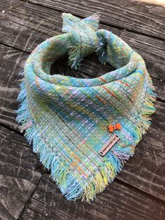 a multicolored scarf on a wooden table