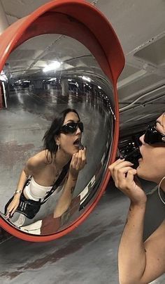 a man and woman are looking at their reflection in the mirror