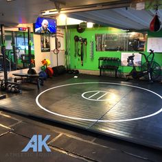 an indoor basketball court in the middle of a gym with exercise equipment on each side