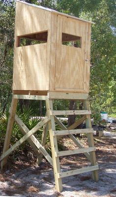 a tall wooden tower with two windows on top