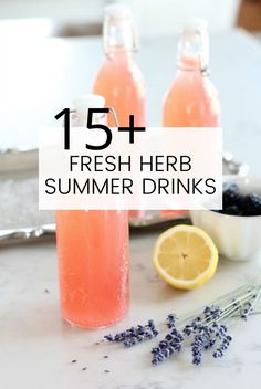 two bottles of fresh herb summer drinks with lavender sprigs and lemons on the side