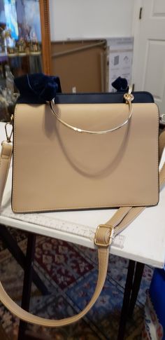 a beige purse sitting on top of a table