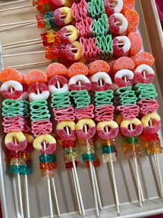 colorful lollipops are arranged on skewers in the shape of letters