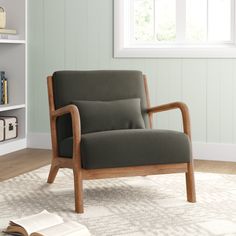 a chair sitting on top of a rug in front of a book shelf filled with books