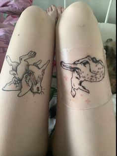 two people with tattoos on their legs, one has a dog and the other has a cat