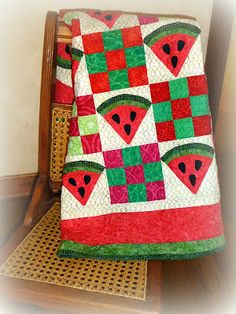 a watermelon quilt is sitting on a chair