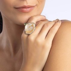 This natural and authentic ring features a free-shaped Baroque pearl, accented by a small Green Sapphire dot on the side. Set in 925 Silver plated with White Rhodium and 18K Gold, this piece is a unique blend of contemporary design and wabi-sabi philosophy, celebrating the beauty of the transient and imperfect. Crafted as a singular piece, it is meant for someone who appreciates the natural elegance of imperfection. Metal: 925 Silver Stones: Baroque Pearl, Sapphire Plating: White Rhodium, 18K Gold  PLEASE NOTE: This ring features a natural Baroque Pearl, which may exhibit color variations, small cracks, and an imperfect surface. These characteristics are not flaws but rather signs of authenticity. September Birthstone Jewelry, Fine Art Jewelry, Zodiac Jewelry, Gifts For New Mums, Jewelry Ring Box, Pearl Jewellery Earrings, Green Sapphire, Men's Jewelry Rings, Evil Eye Jewelry