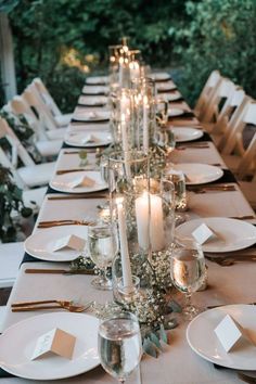 the table is set with candles and place settings