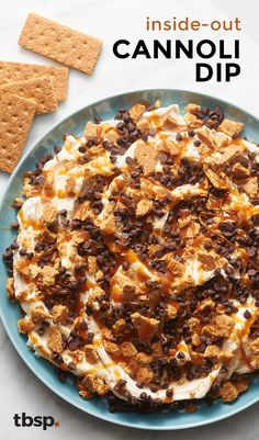 the cover of inside - out cannoli dip is shown on a plate with crackers